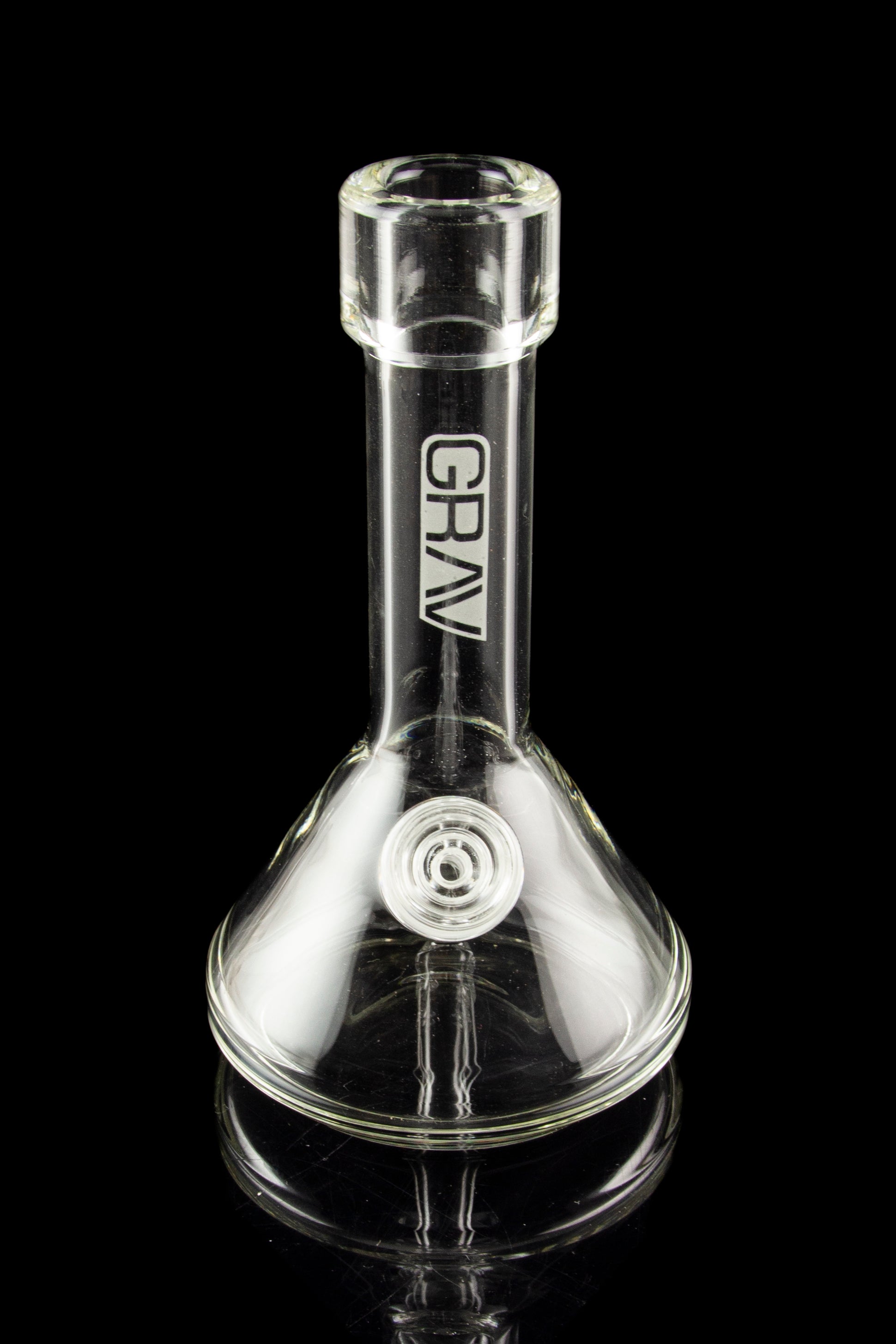 Clear glass water pipe (bong) with “GRAV” logo and ice pinch, reflecting on a black surface.