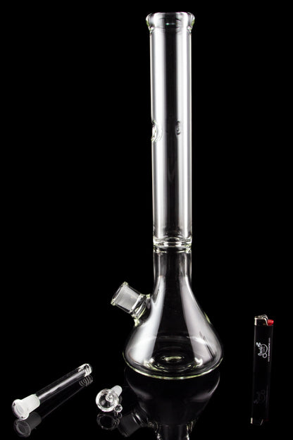 Clear glass bong with attachments on a black background.