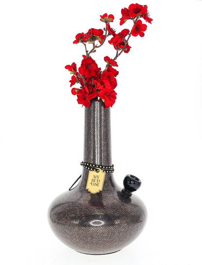 A front view of the ornate “My Bud Vase Burmese” water pipe, featuring a detailed, sculpted glass design.