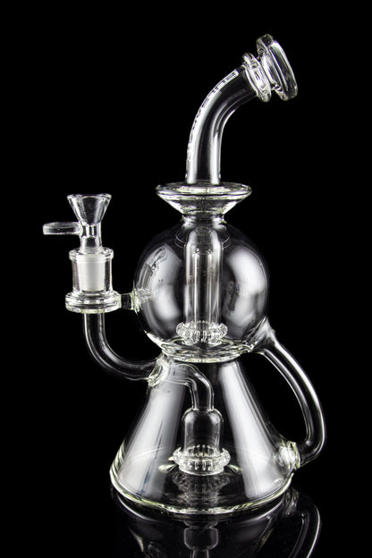 Clear glass water pipe (rig) with intricate bubbler design, isolated on black.