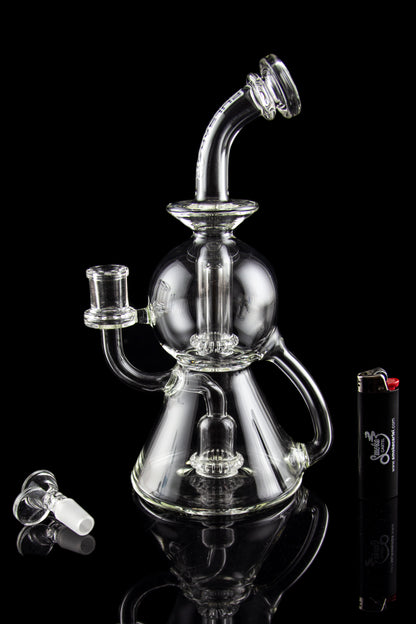 Clear glass water pipe (bong) with multiple chambers and a glass bowl, displayed on a black background.