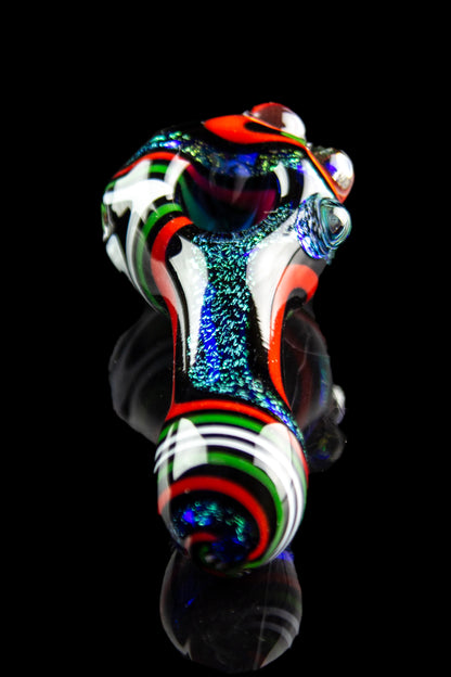 Colorful glass pipe with swirling red, white, and green patterns against a black background.