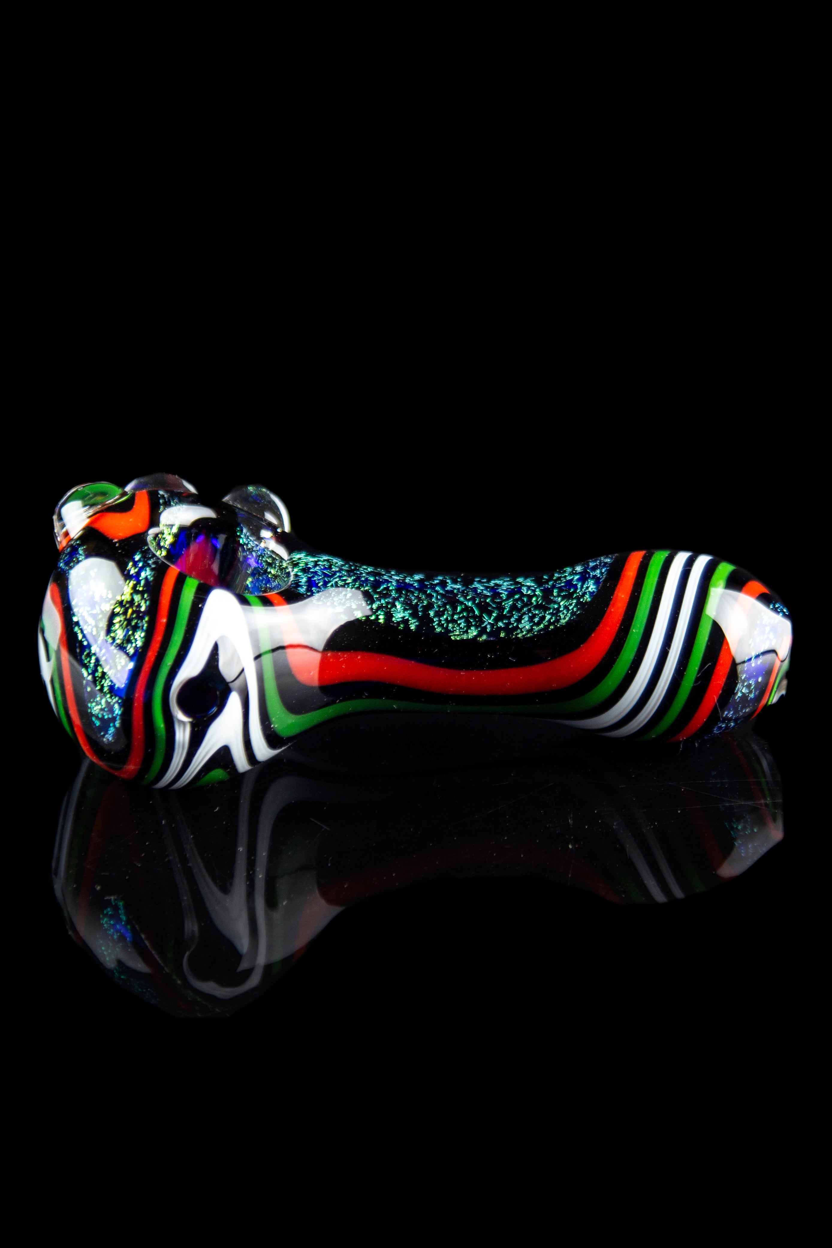 Colorful glass cannabis pipe with iridescent glitter accents, displayed on a reflective black surface.