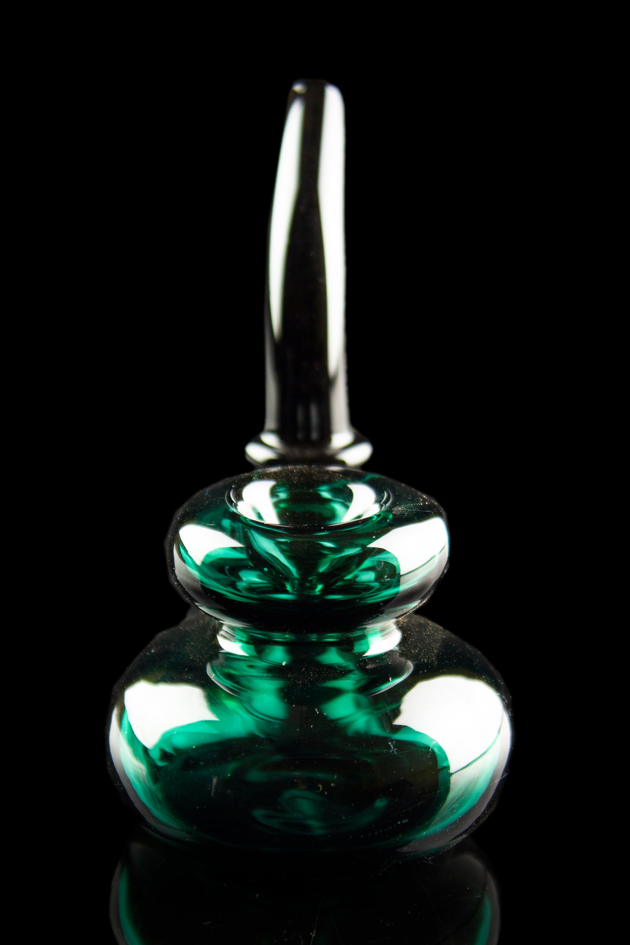 Emerald green glass oil rig with a bubbler design, isolated on black.