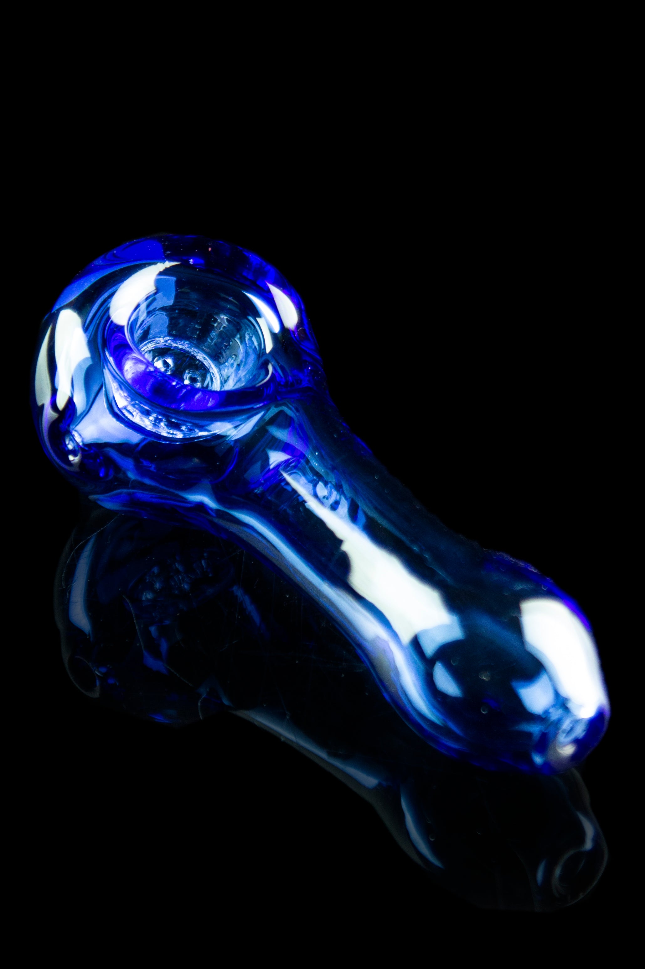 Blue glass pipe against a black background.