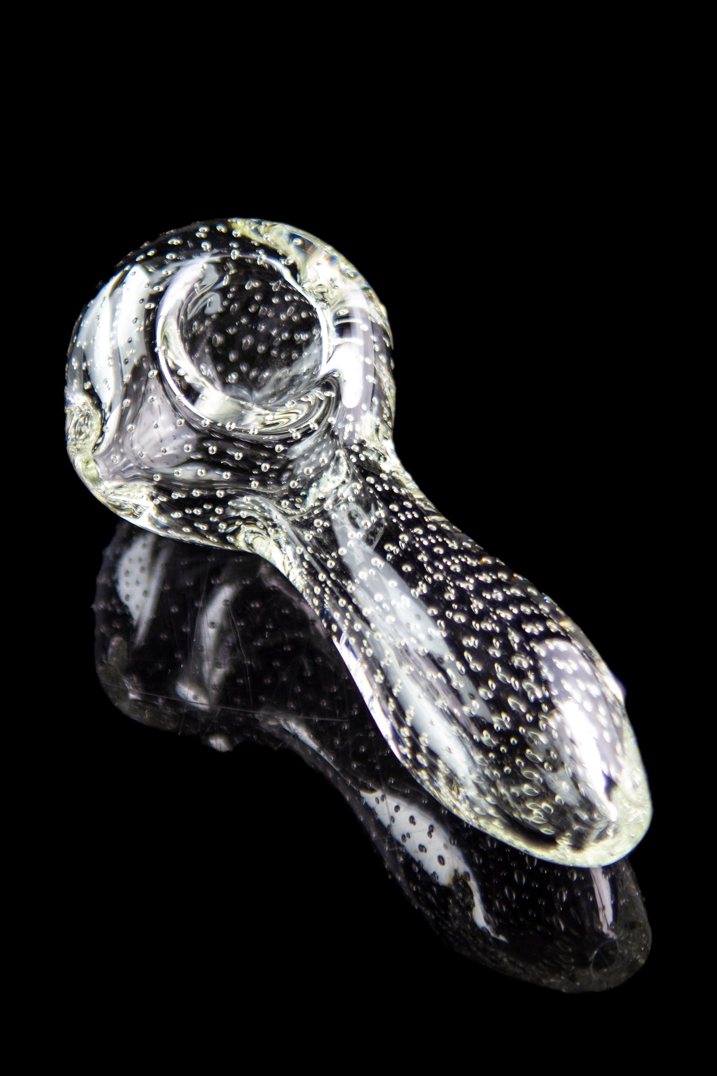 A close-up, angled view of the Pulsar Bubble Matrix Spoon Pipe, showcasing its clear glass construction and bubble detailing.