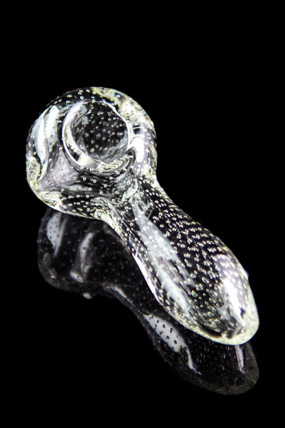 A close-up, angled view of the Pulsar Bubble Matrix Spoon Pipe, showcasing its clear glass construction and bubble detailing.