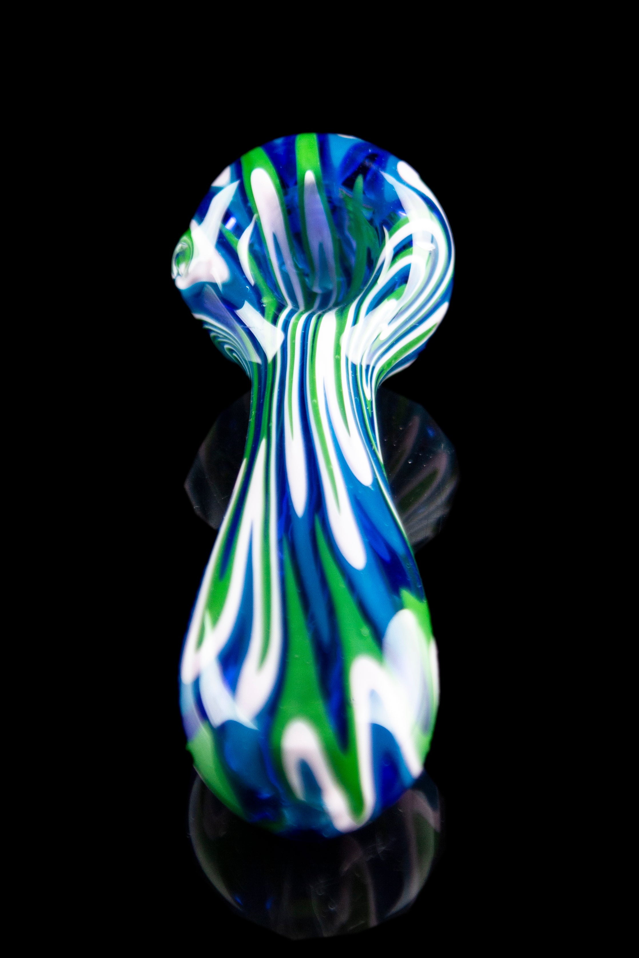 A vibrant, swirling glass pipe with green, blue, and white patterns, isolated on a black background.