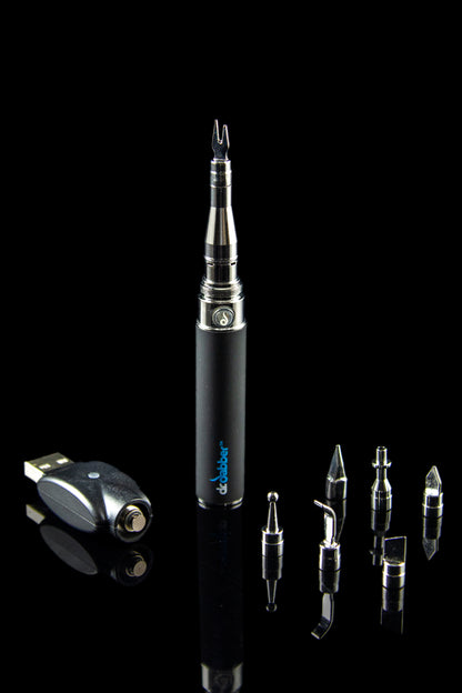 A studio shot displays the Dr. Dabber Budder Cutter alongside similar metallic tips arranged diagonally on a black surface.