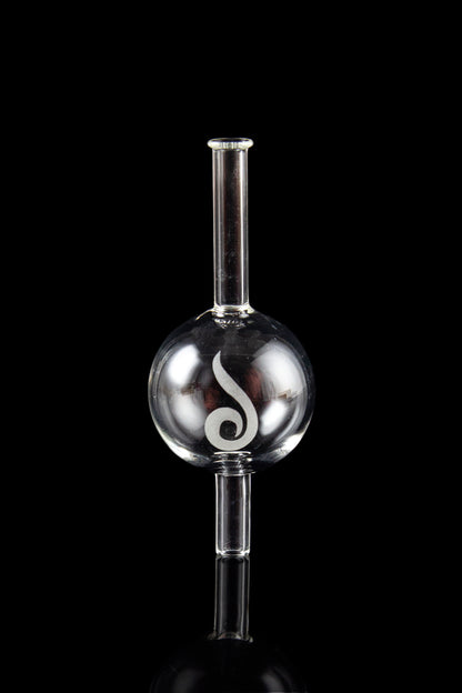 Glass oil rig with spherical water chamber and intricate white design, reflected on a dark surface.