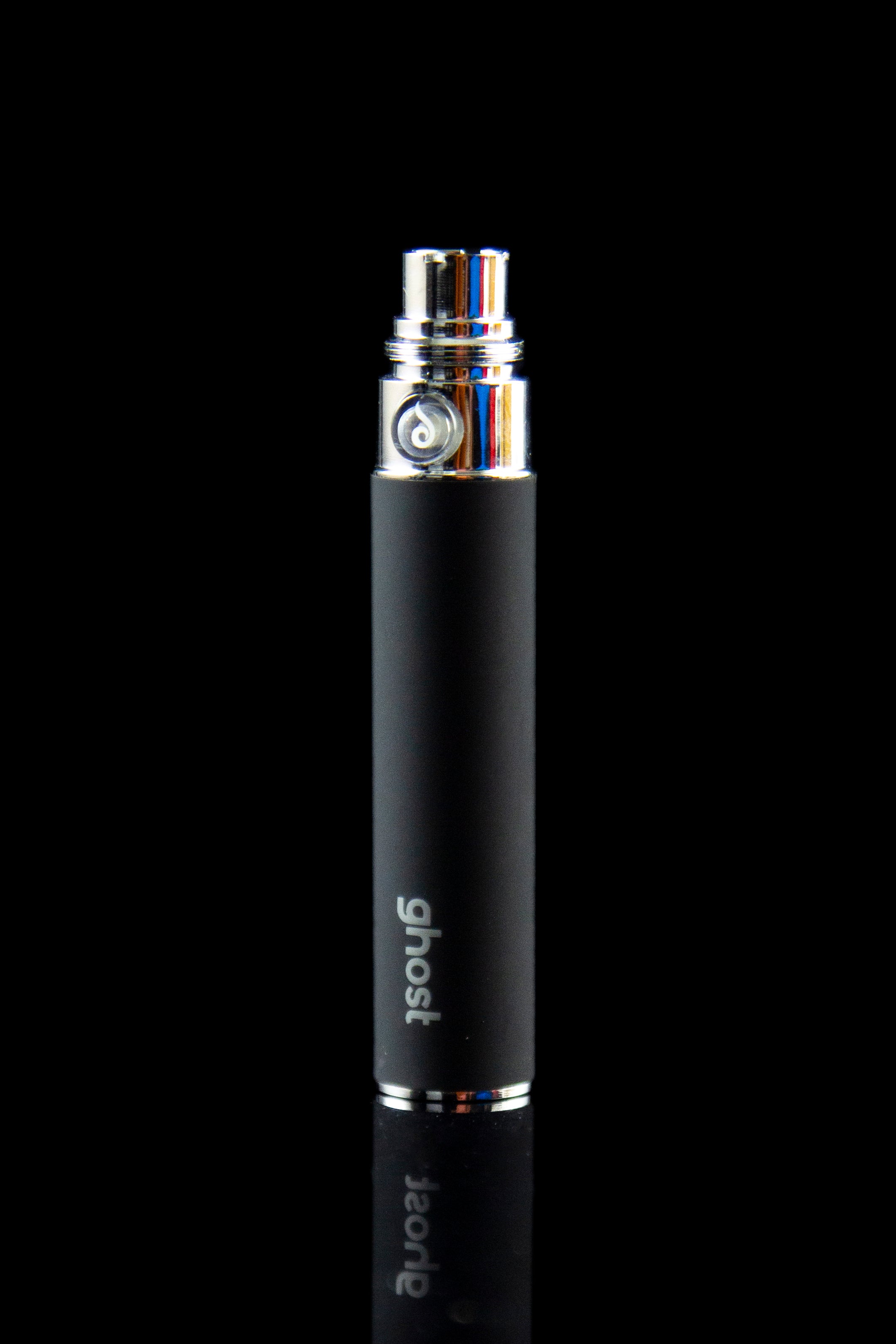 Black "Ghost" branded vaporizer pen with a colorful glass mouthpiece, reflecting on a dark surface.