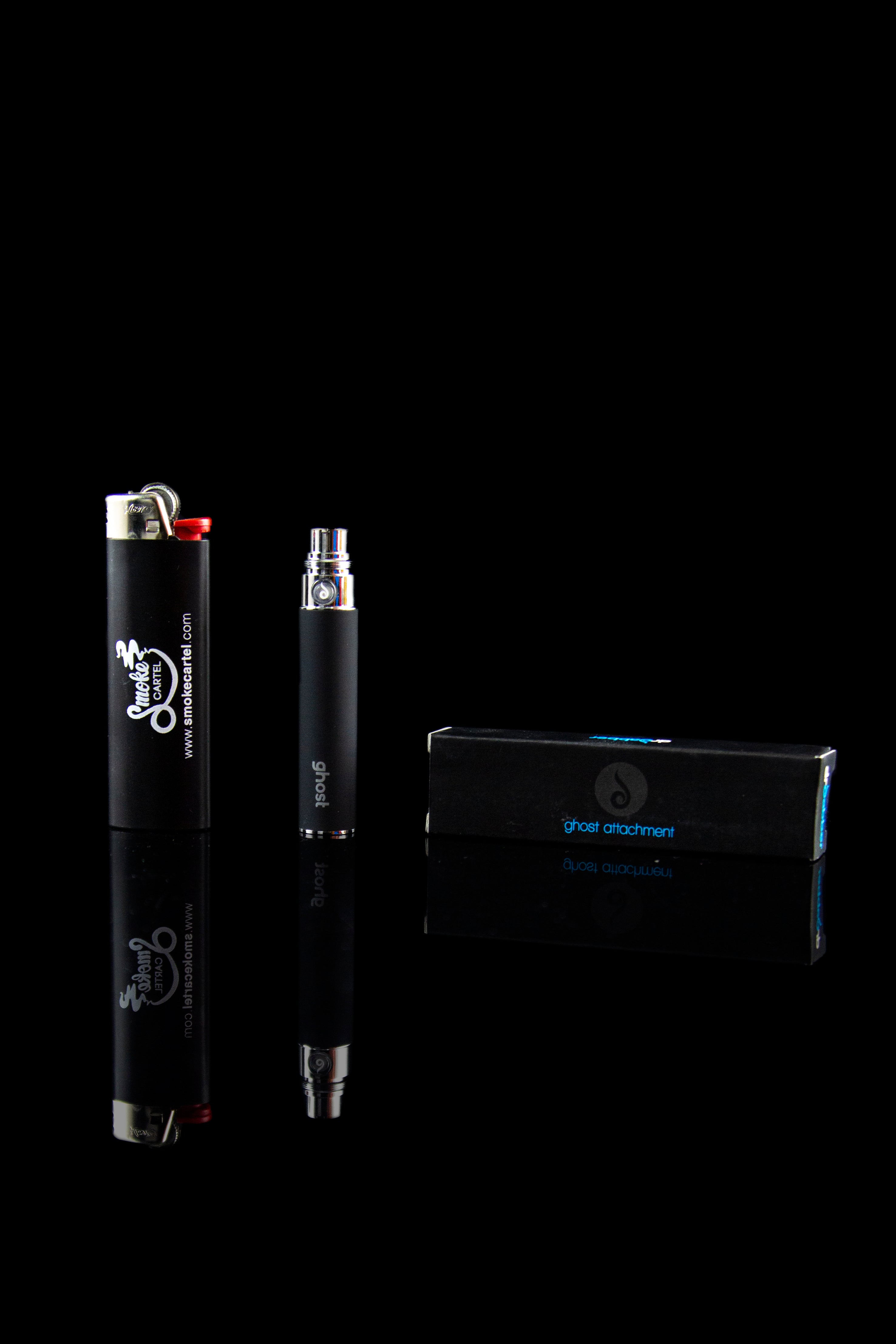 Black cannabis oil vaporizer pen and packaging on a reflective surface.