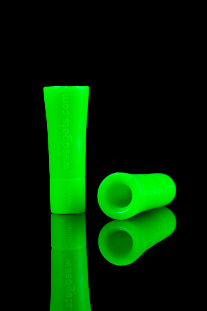 Glowing green glass cannabis mouthpiece and tip.
