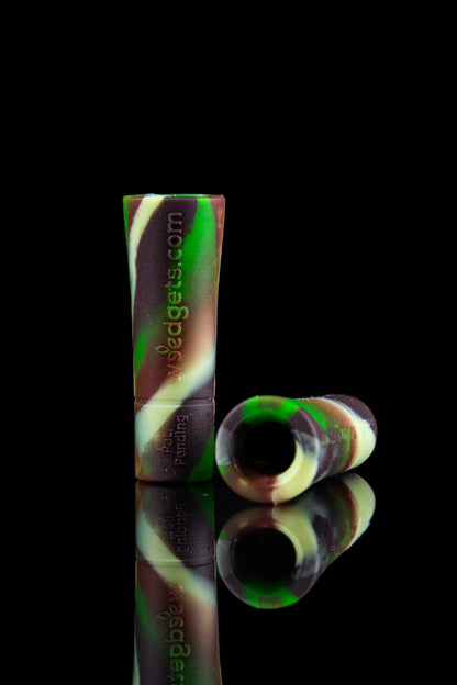 Green and maroon silicone oil rig with a glass bowl, reflected on a black surface.