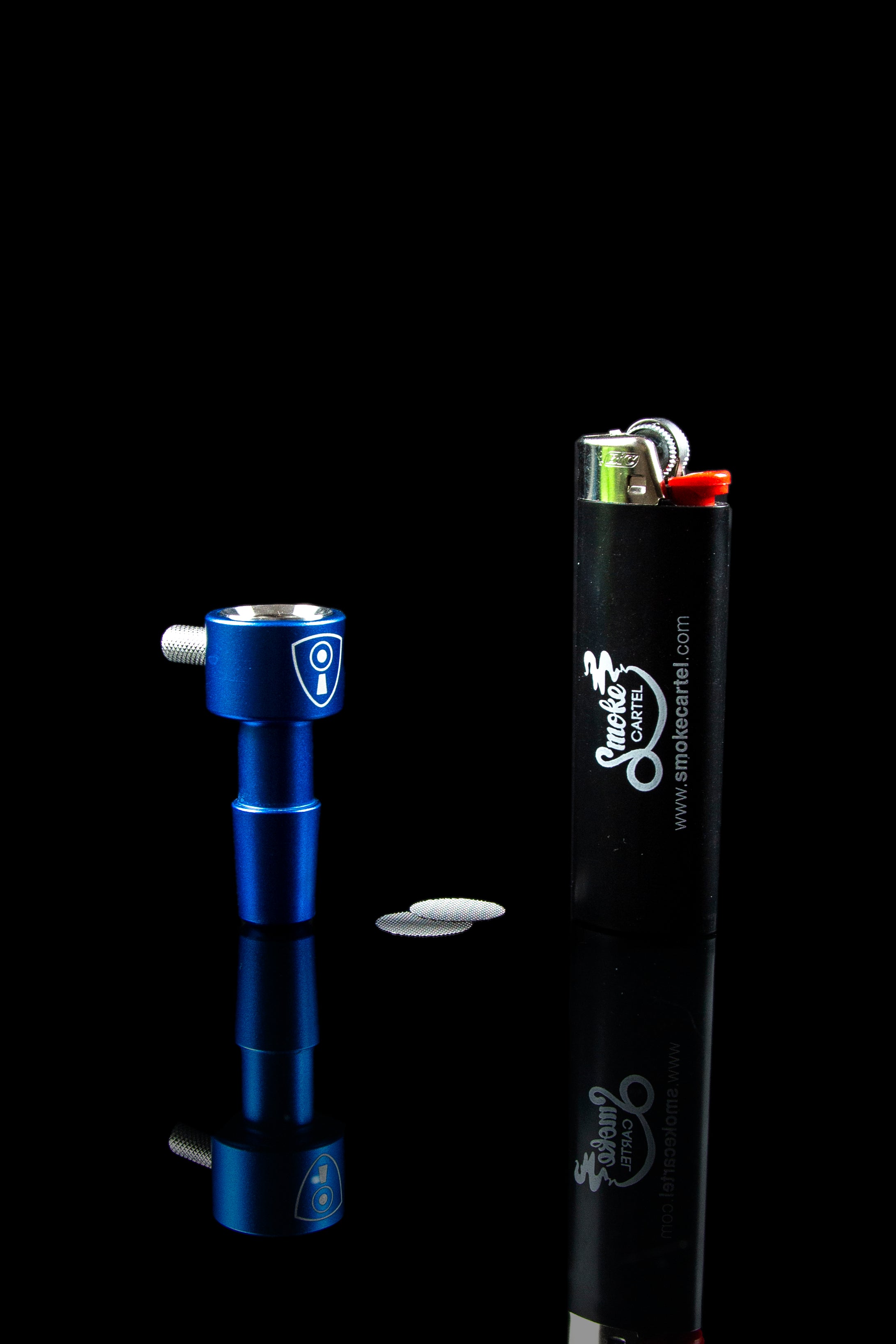 Blue dab tool and black lighter with "Smoke Cartel" branding against a black background.