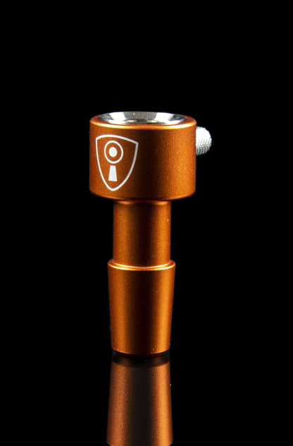 Copper-colored cannabis dab rig with a shield-shaped logo.