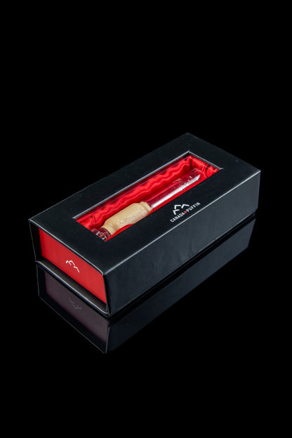 Black gift box containing a rolled cannabis joint with a “Canada Puffin” logo.
