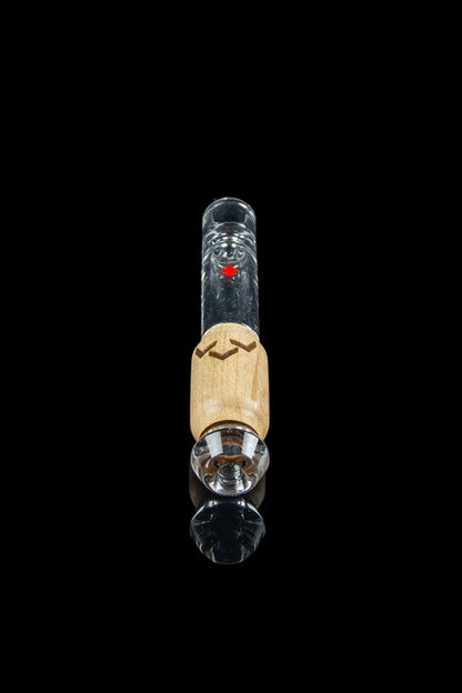 Glass dab rig with wooden accent and clear glass components, isolated on black.