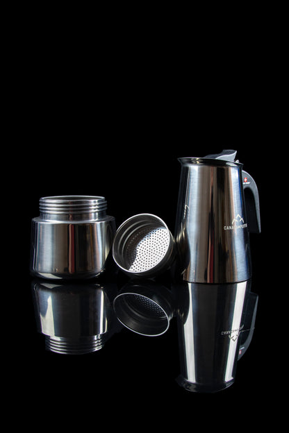 Stainless steel cannabis bubbler with disassembled parts and reflections on a black surface.