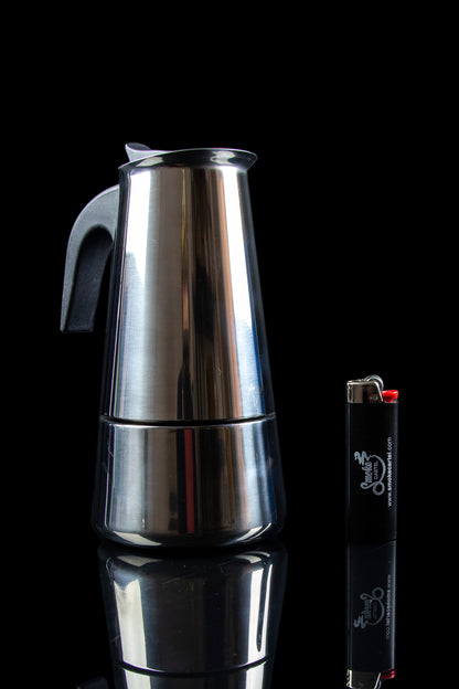 Silver grinder and black lighter against a dark background.