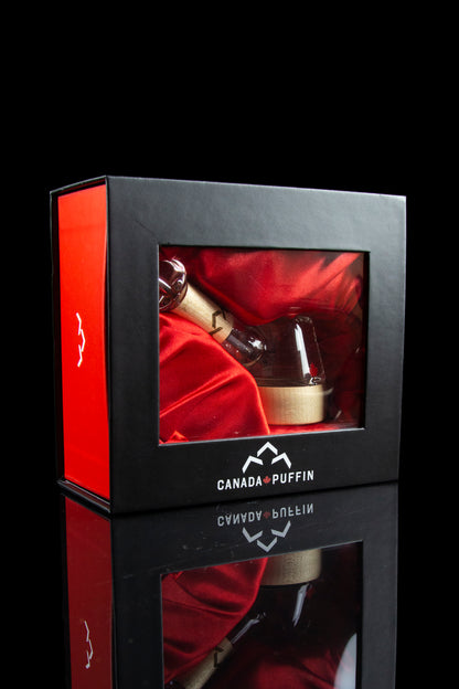 Red gift box with cannabis accessory inside, branded “Canada Puffin” with a reflective surface.