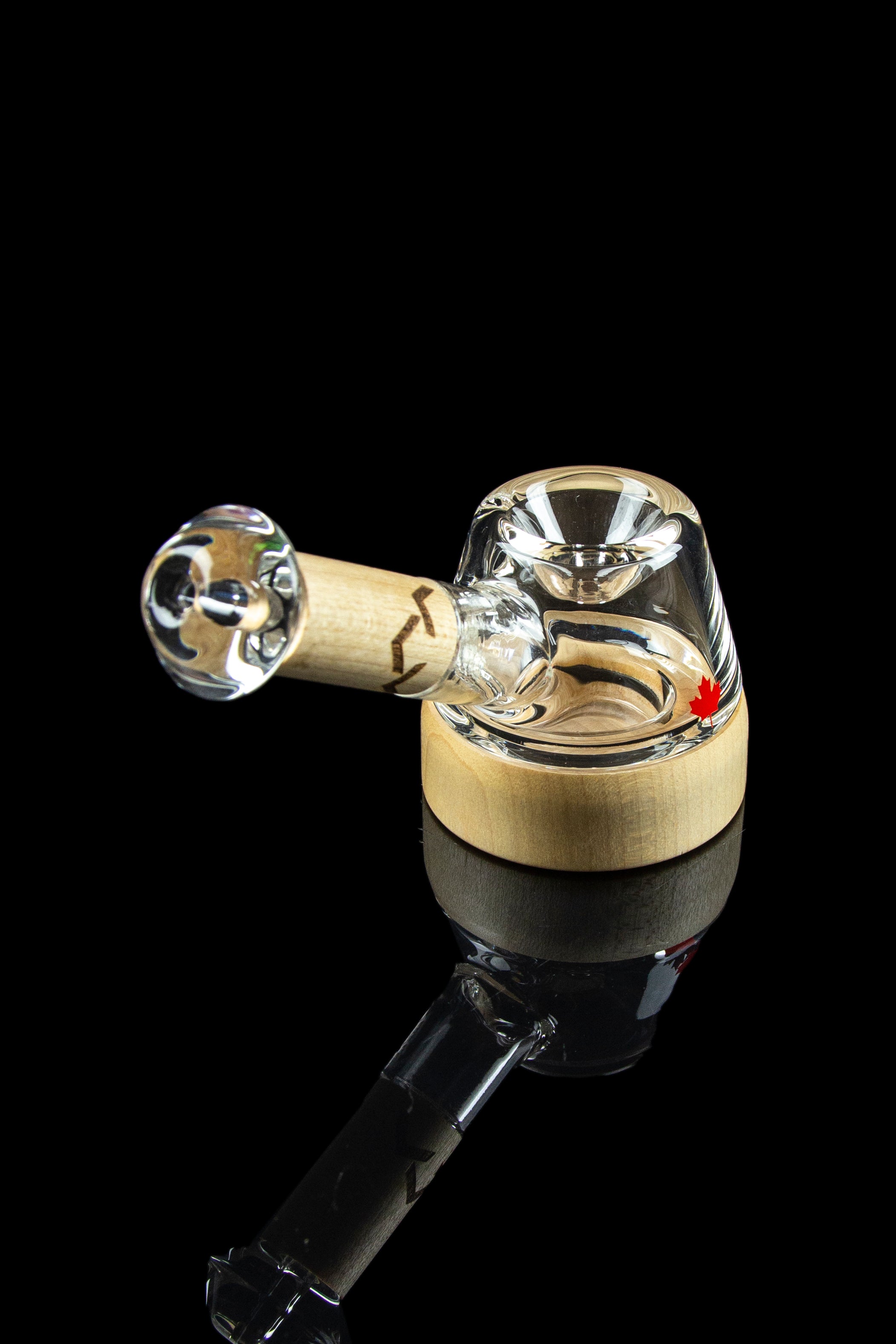 A clear glass bubbler pipe with a wooden mouthpiece, isolated on a black background.
