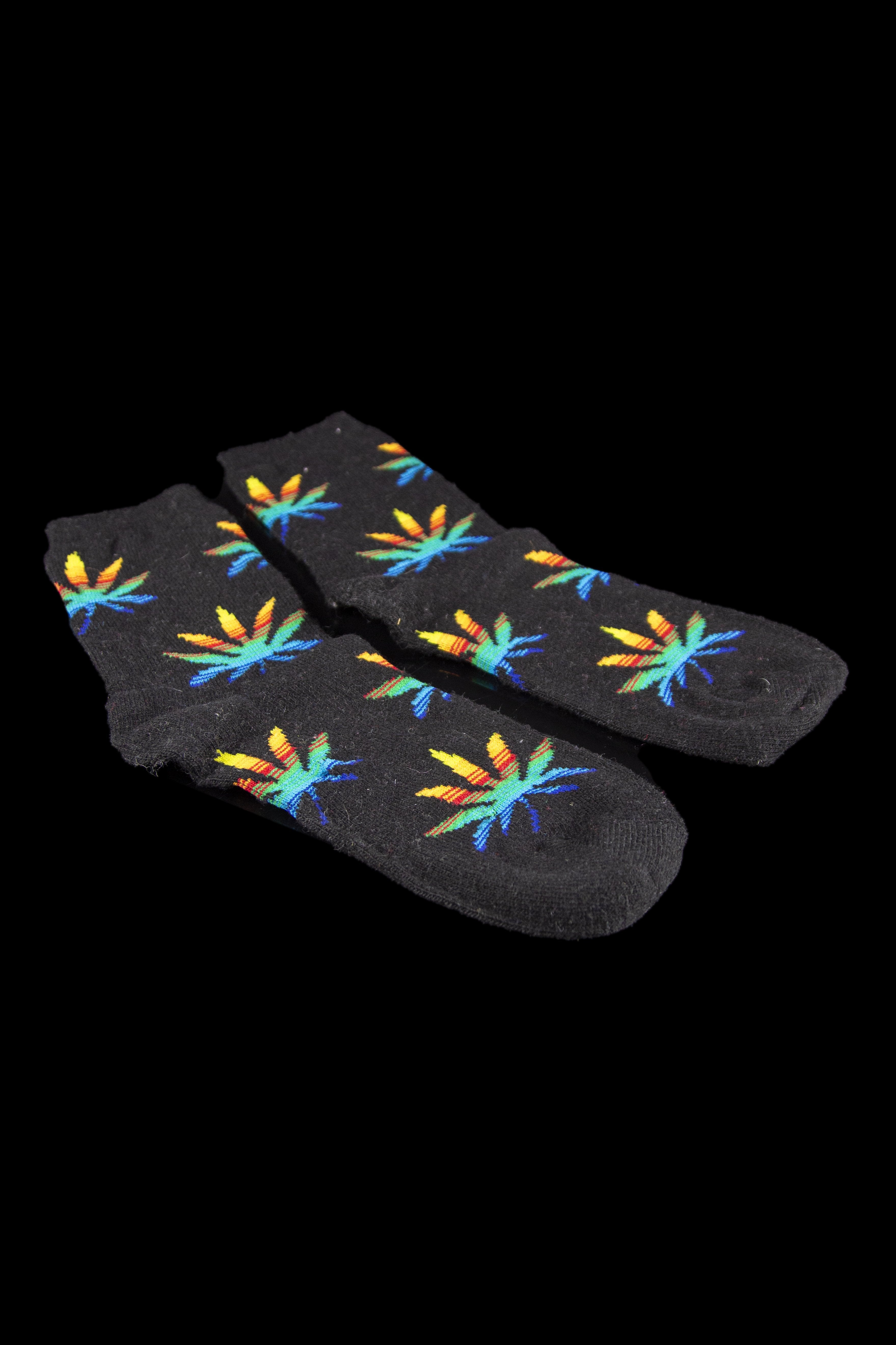 Black socks patterned with colorful cannabis leaves.
