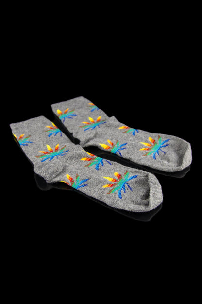 Gray cannabis leaf-patterned socks laid flat on a black background.