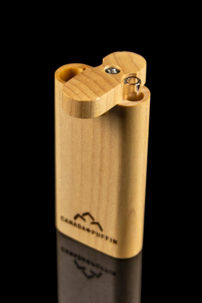 Wooden lighter with cannabis leaf logo and visible flint wheels.
