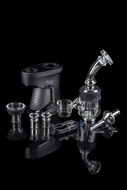 A black doob e-nail with various glass water pipes and attachments displayed on a black surface.