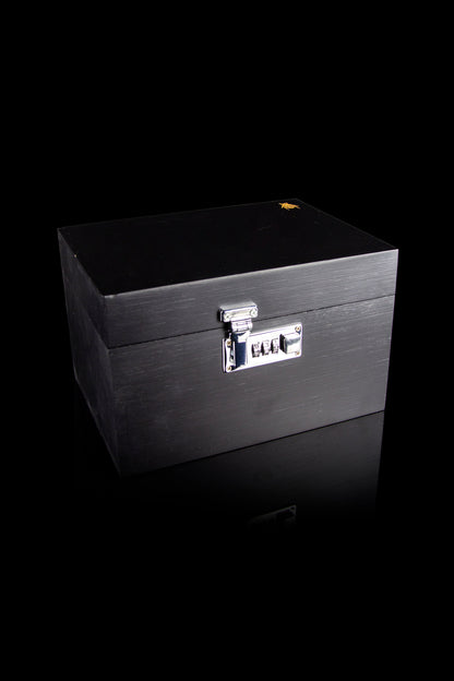 Black cannabis storage box with combination lock, isolated on a black reflective surface.
