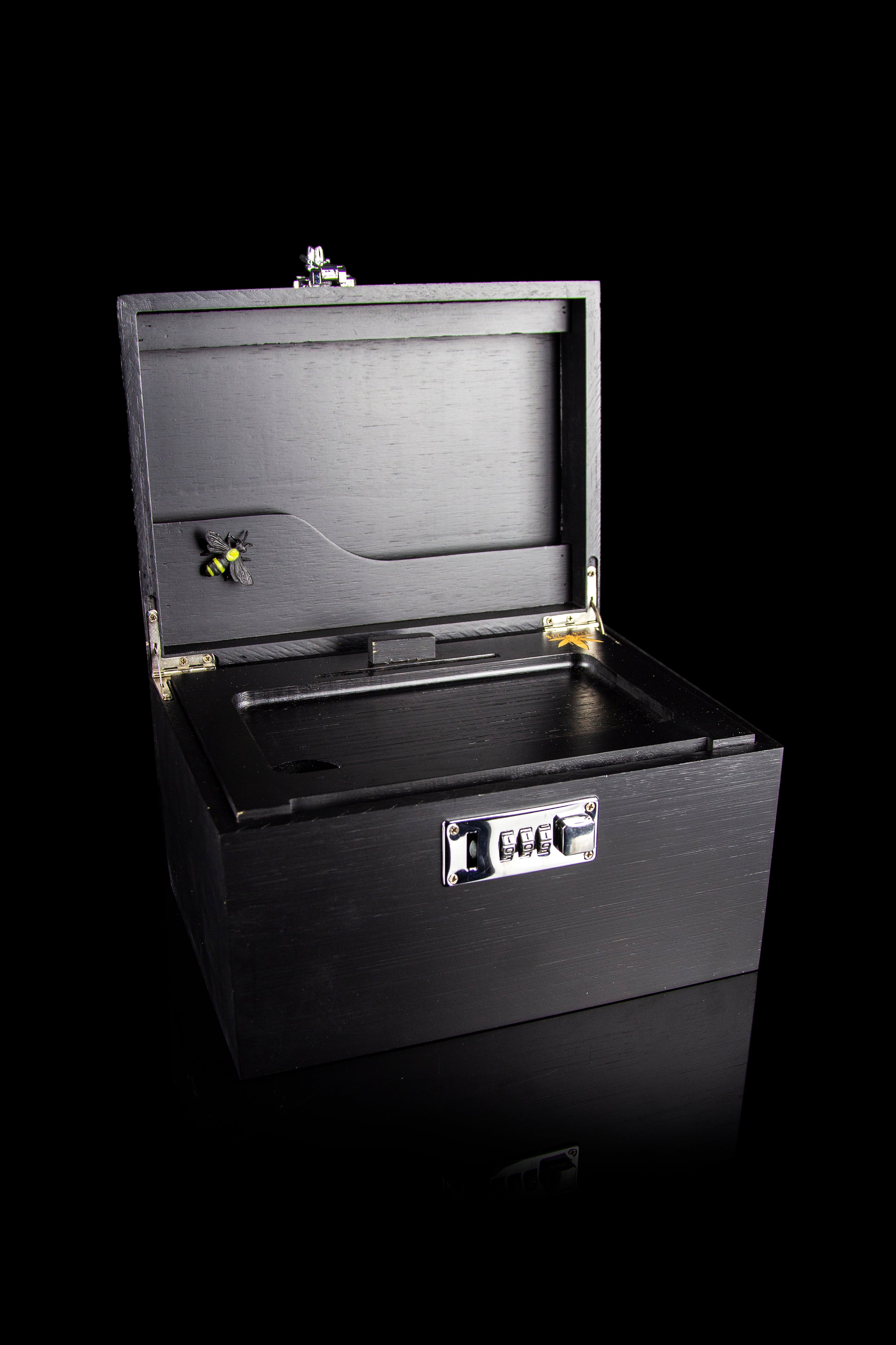 Black cannabis storage box with combination lock and visible buds inside.