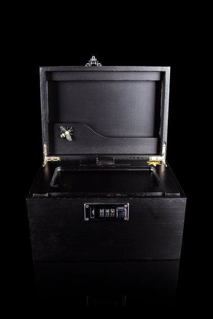 Open black cannabis storage box with combination lock.