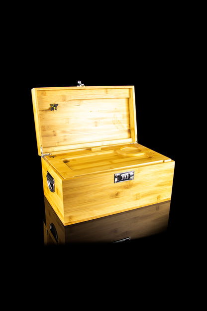Wooden cannabis storage box with open lid and interior compartments, isolated on black.
