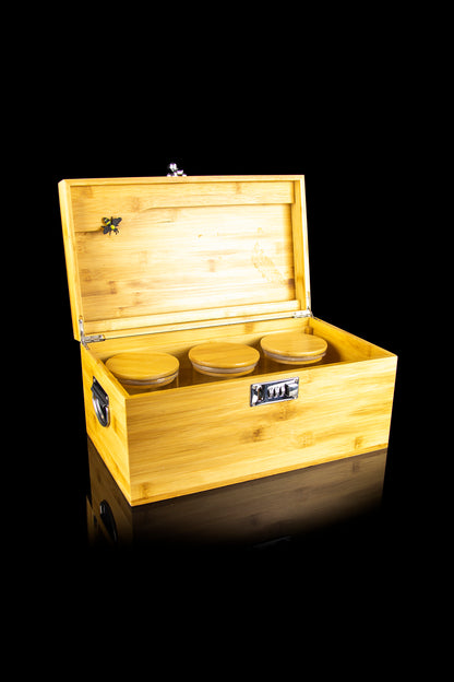 Wooden cannabis storage box with three airtight jars inside, displayed on a reflective surface.