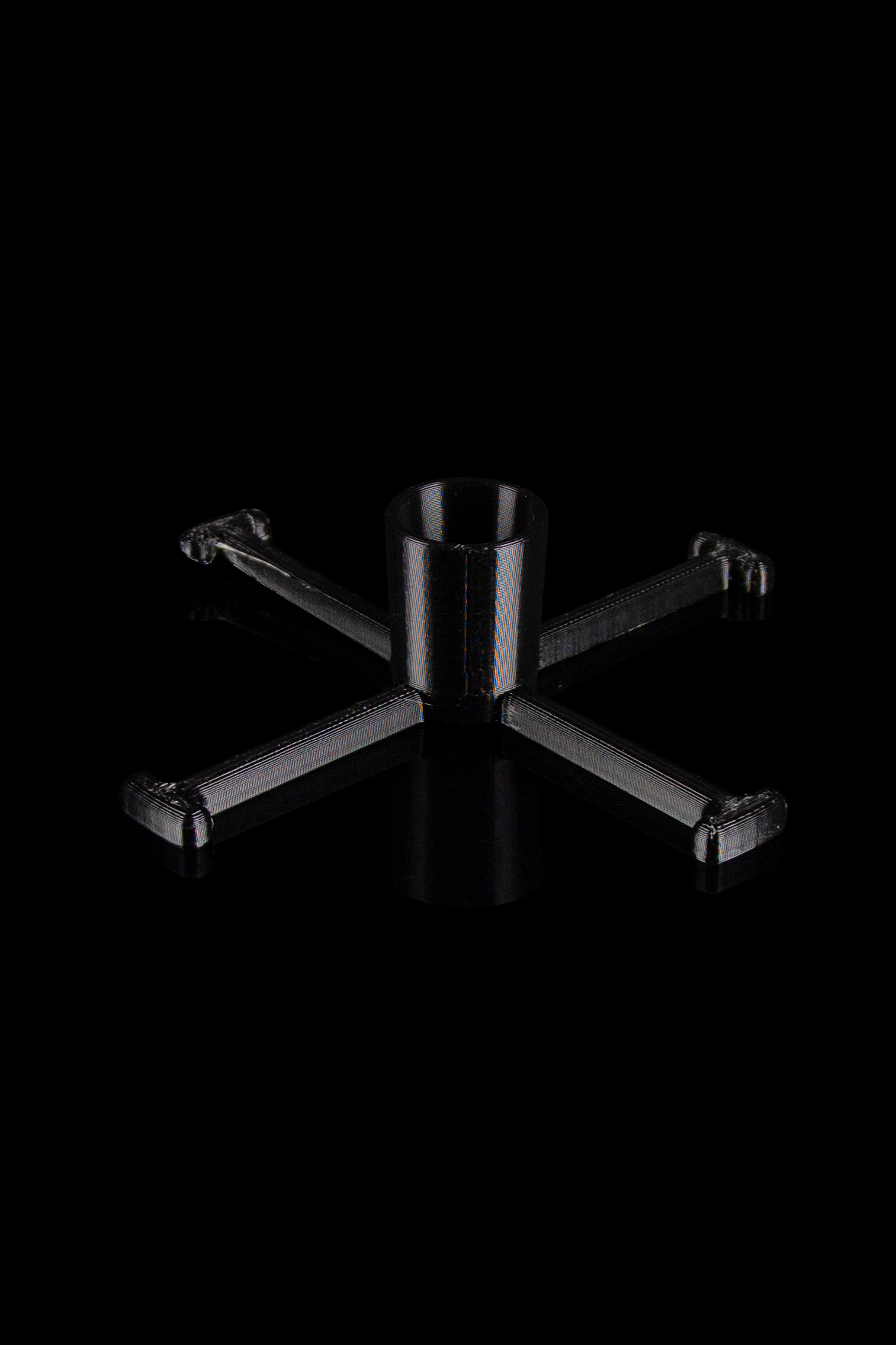 Black cannabis water pipe stand with a textured, carbon fiber-like pattern.