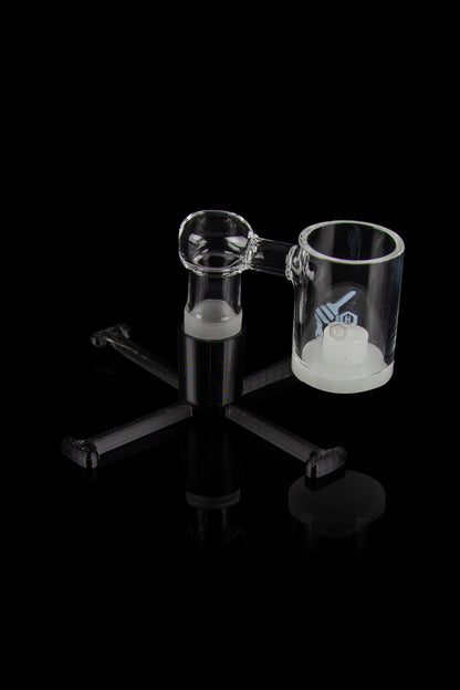 Clear glass dab rig with three attachments on a black background.