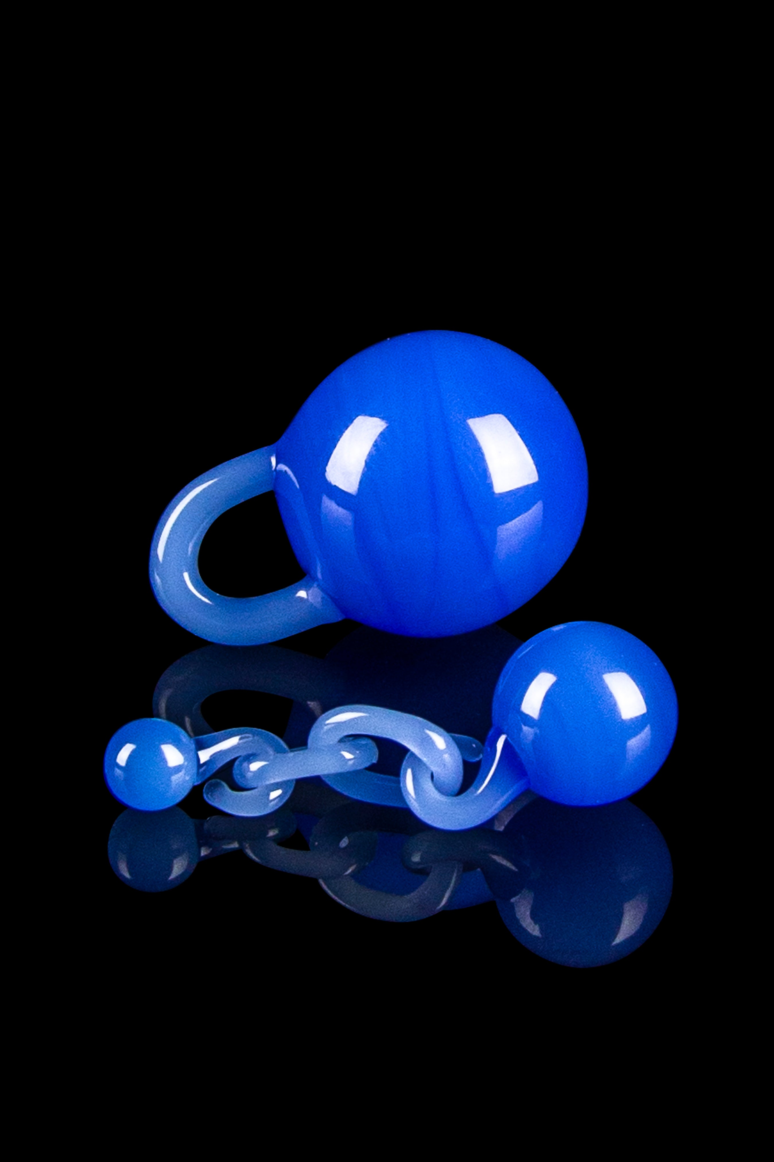 Blue glass water pipe with intricate curves and a reflective surface, isolated on black.