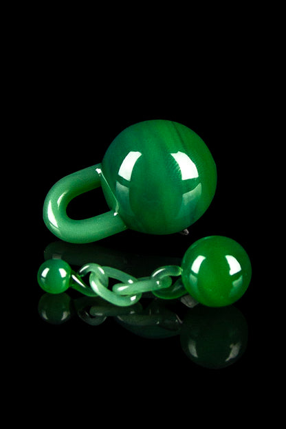 Glossy green cannabis-themed chain and sphere against a black background.