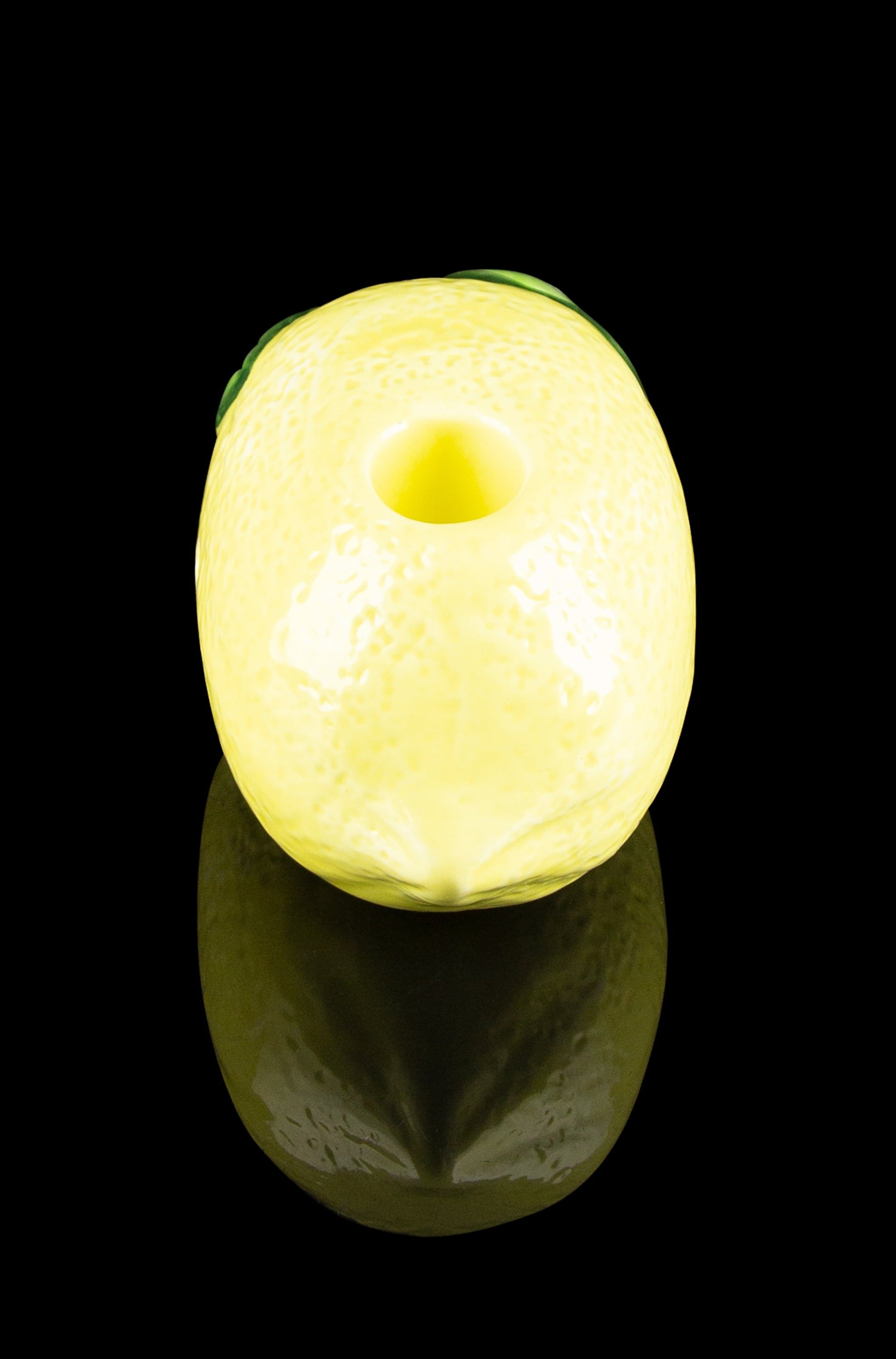 Glowing yellow cannabis-inspired donut-shaped light with a glossy reflection.