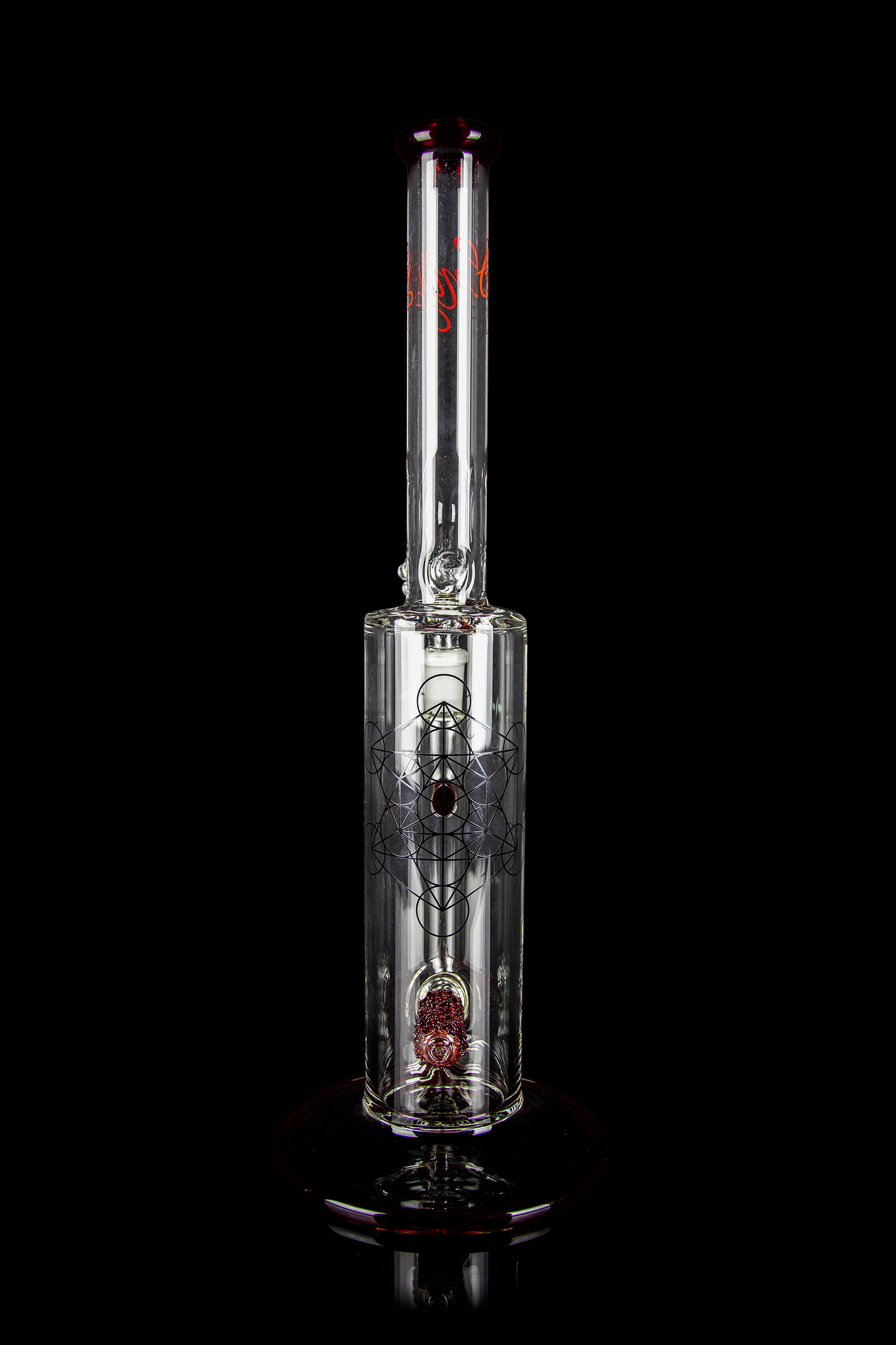 Glass water pipe (bong) with intricate etched design and red accents, isolated on a black background.