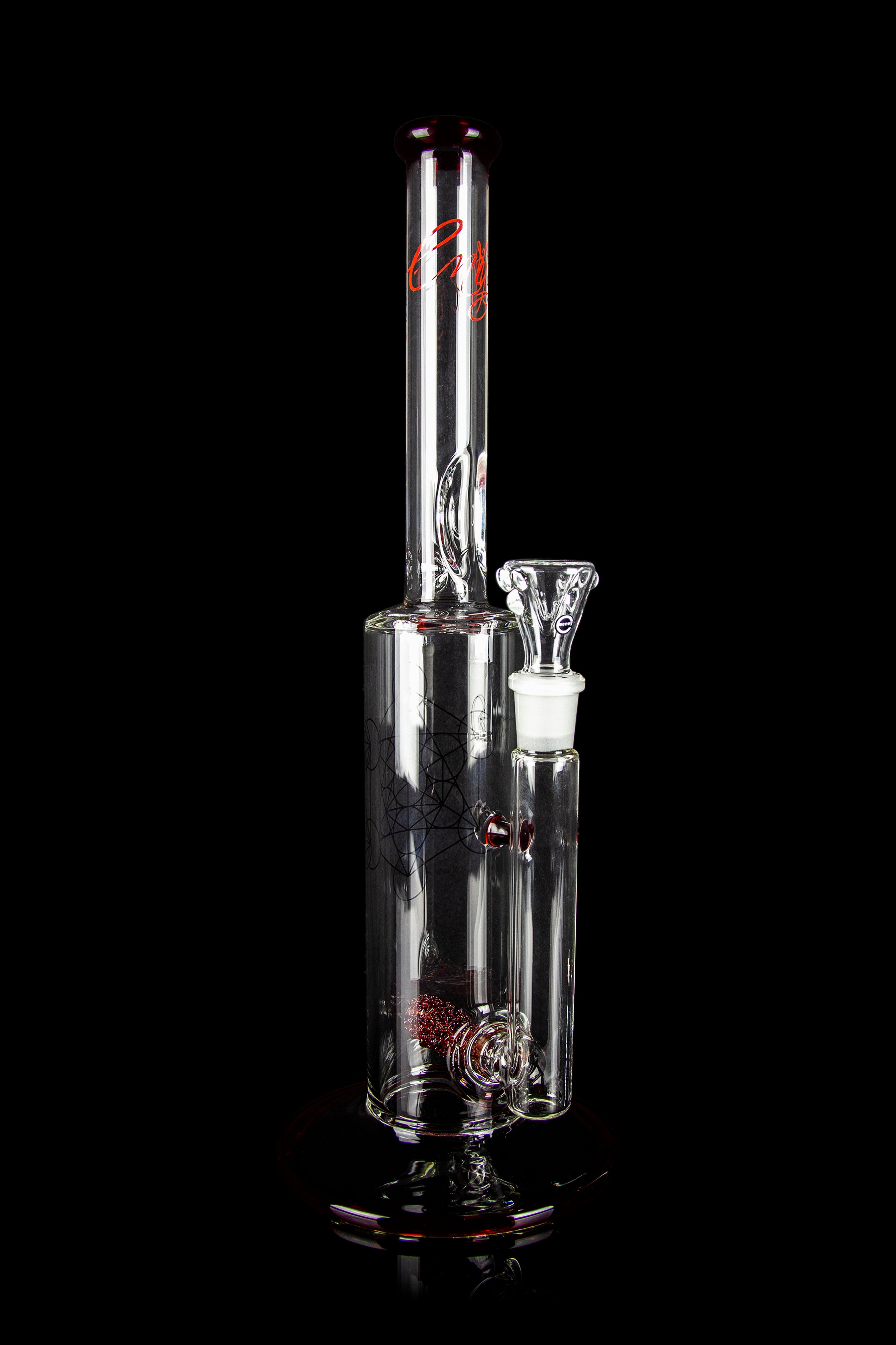 Clear glass water pipe (bong) with red accents and intricate web-like designs, studio shot on black background.