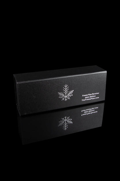 Black box for “Freeze Pipe Revolver 2023 Edition” with a snowflake design, reflecting on a glossy surface.
