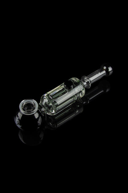 Clear glass rig with intricate bubbler design, isolated on a reflective black surface.