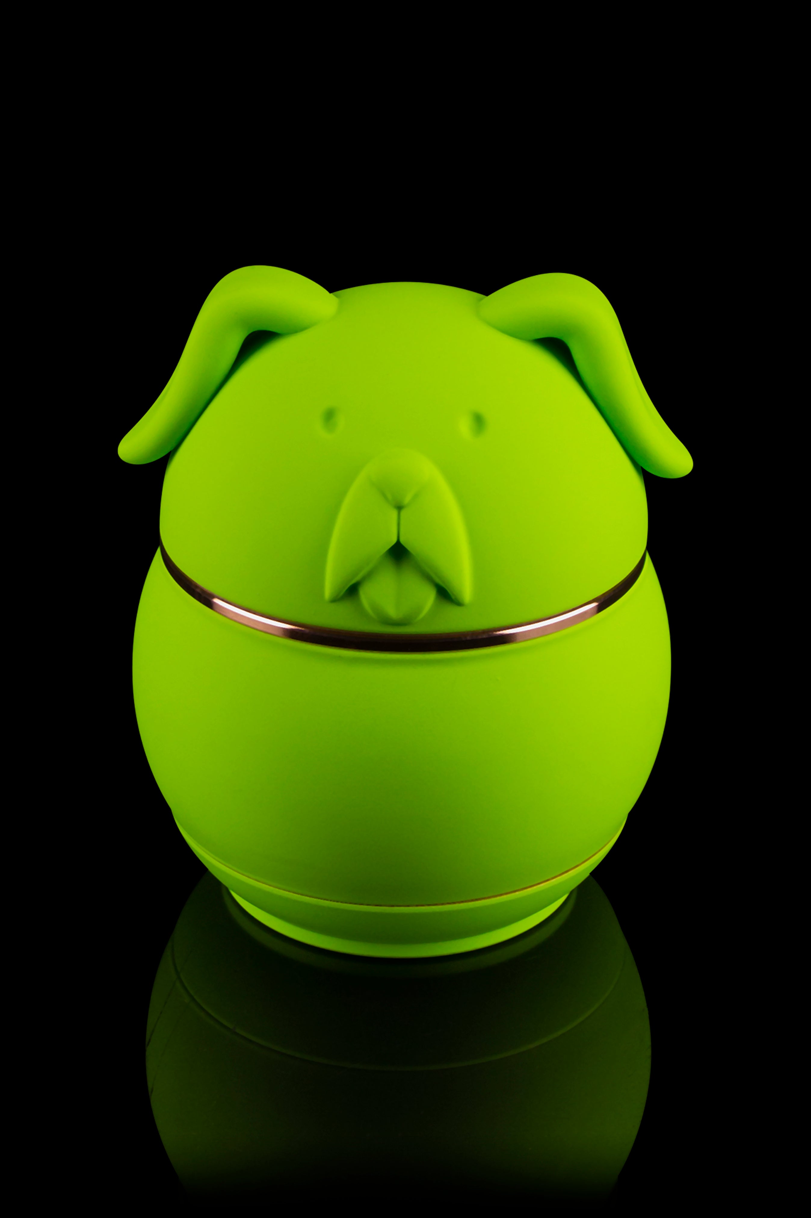 Green dog-shaped silicone container with a reflective band, likely for storing cannabis.