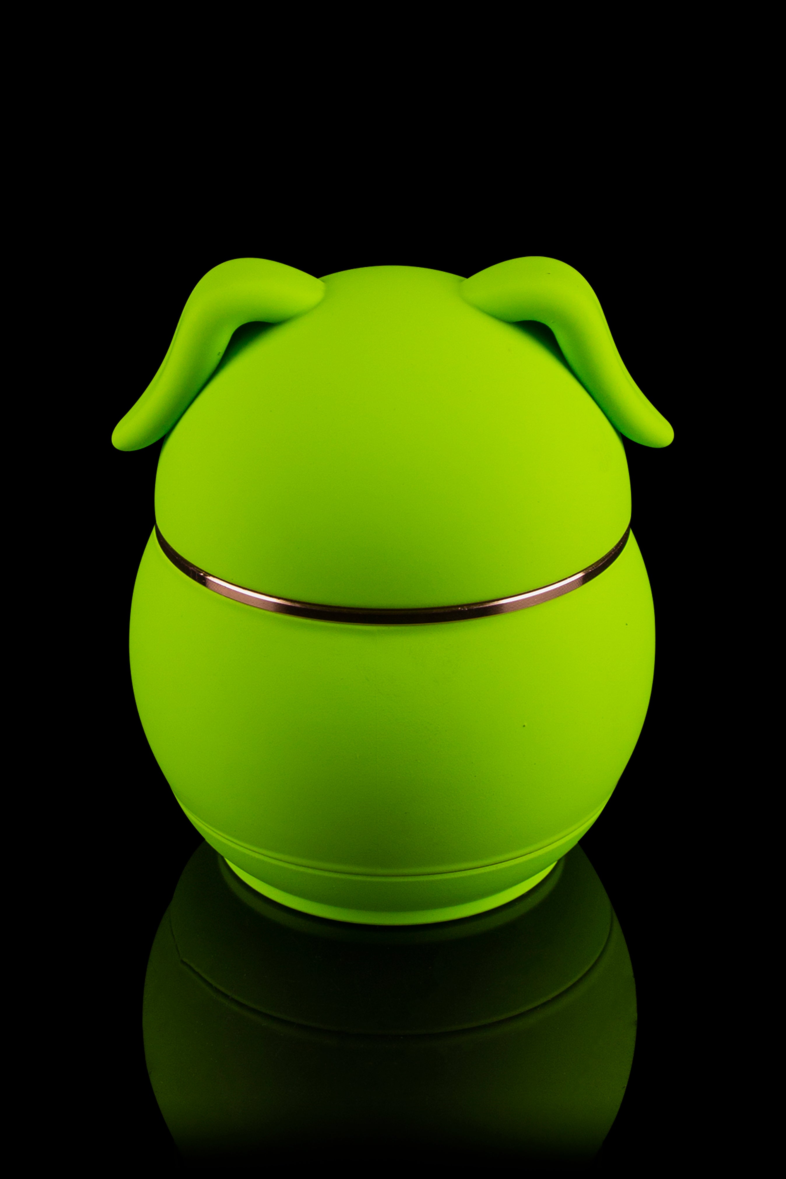 Bright green, spherical cannabis storage jar with pig-ear-shaped handles, reflecting on a black surface.