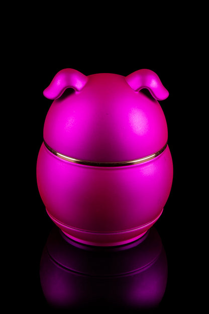 Bright pink silicone cannabis concentrate container with reflective base.