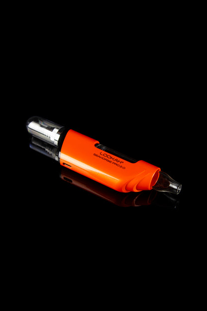 Orange cannabis oil vaporizer pen with visible oil reservoir against a black background.
