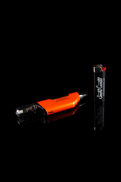 Orange and black cannabis vaping device with a lighter on a black background.