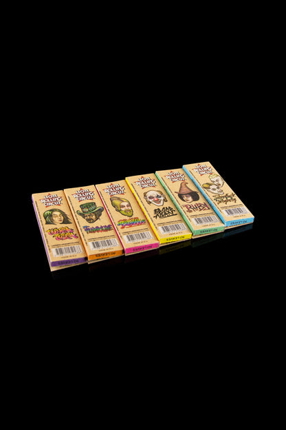 Assortment of colorful “Lion Rolling Circus” rolling paper booklets stacked against a black background.
